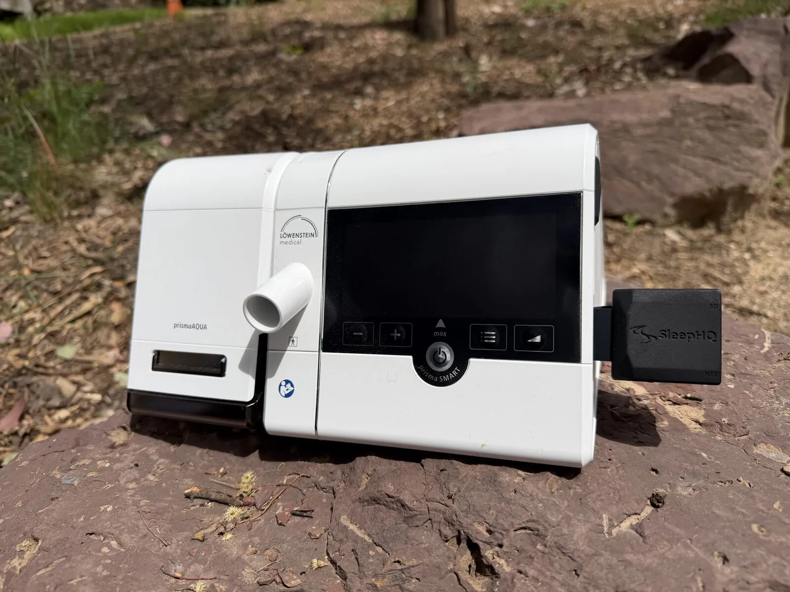 A MUX inserted in the SD card slot on the side of a white Löwenstein prisma SMART