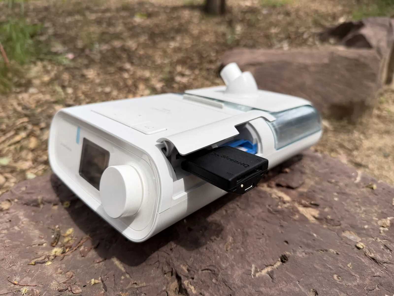A MUX inserted in the SD card slot under the side flap of a Philips DreamStation