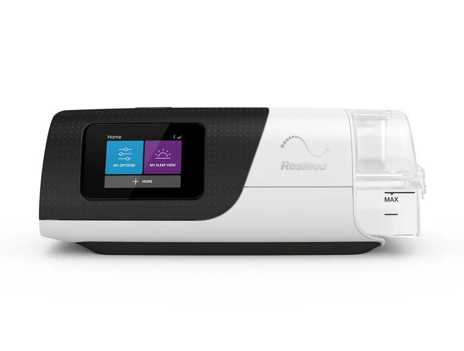 A ResMed AirSense 11, seen front on with its humidifier attached