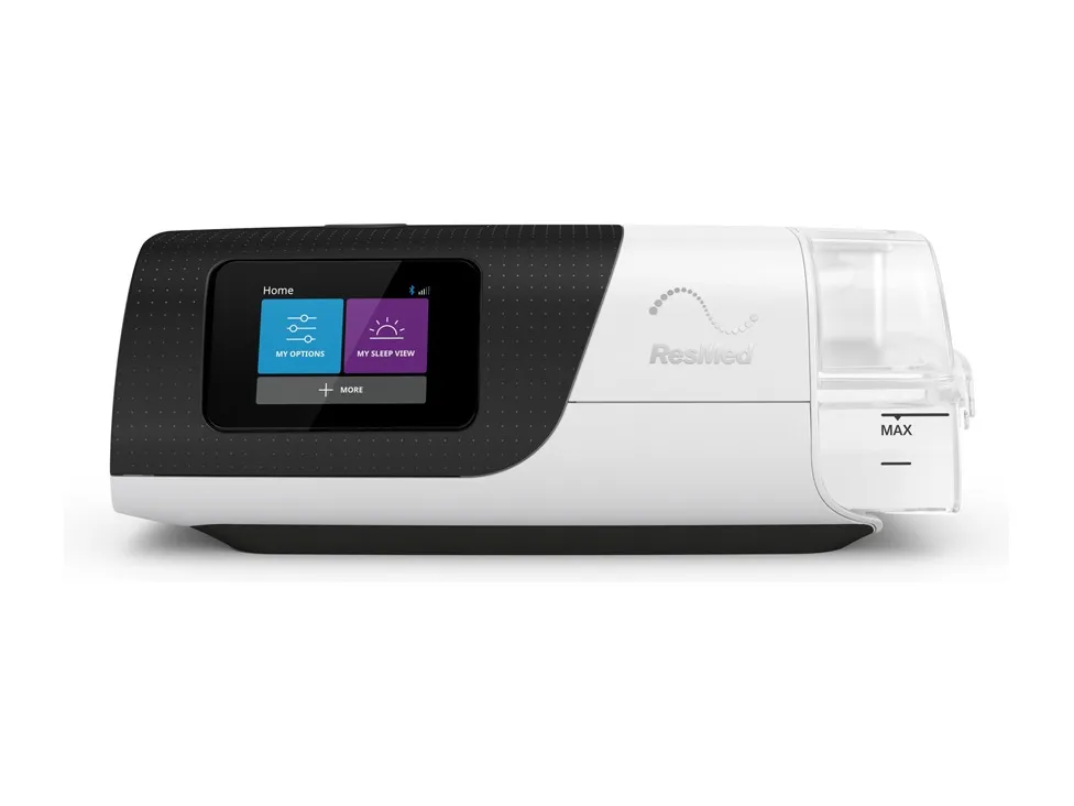 A ResMed AirSense 11, seen front on with its humidifier attached
